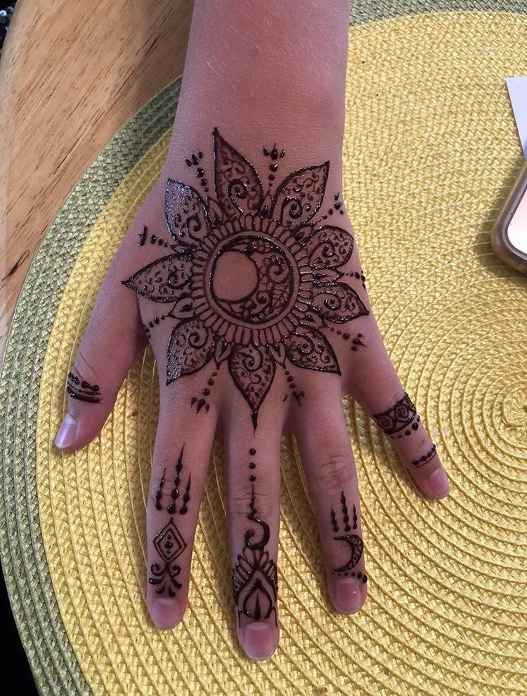 Fresh freehand henna artwork with curved details